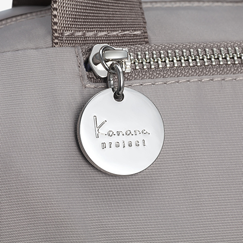 The zipper pull of the upper front pocket has a simple, clean design with the Kanana Project logo.