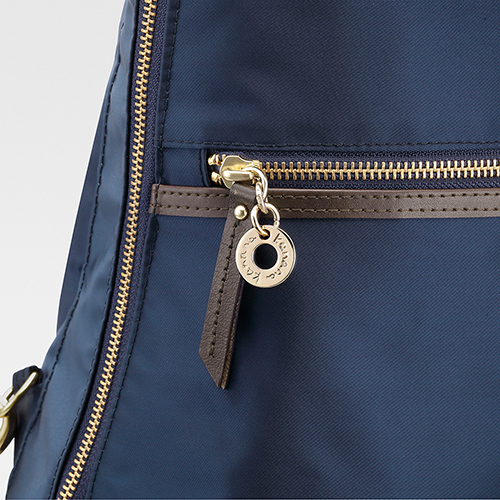 The front pocket’s leather zipper strap and gold charm give the backpack an elegant, refined look.